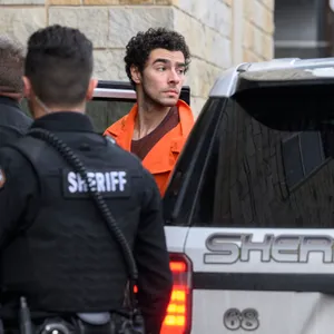 A suspect is in custody. Some Americans are celebrating his alleged actions